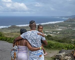 Family looks out over a bay in Barbados.