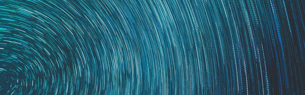 Time-lapse photo of star trails in the night sky.