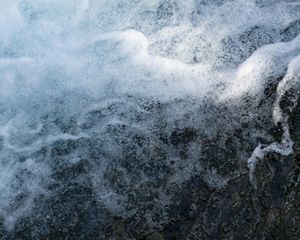 Fast moving water splashes in whitewater rapids.