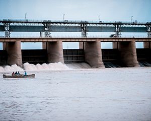 photo of a small boat near a hydropower dam in a river