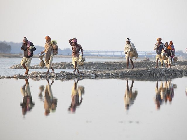 Villagers walk along the banks of the Ganges River in Haridwar.